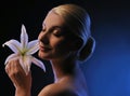 Woman with lily flower toned in blue Royalty Free Stock Photo