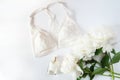 Woman lingerie with accessories and flowers collage on white, flat lay, top view. Royalty Free Stock Photo