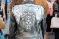 Woman with lion head print on black leather jacket before Cristiano Burani fashion show, Milan Fashion Week