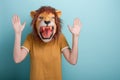 Woman in lion mask holding hands up in defense or stop gesture