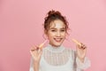 Woman with lip gloss. Photo of woman with perfect makeup on pinkbackground. Beauty concept