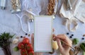 Woman list on the note for vegan health food and zero waste lifestyle. plastic free grocery shopping. Top view. Flat lay Royalty Free Stock Photo