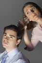 Woman Listening Through Glass To Man's Head