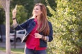 Woman listening music from smart phone with headphones outdoor a Royalty Free Stock Photo