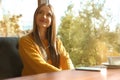 Woman listening to audiobook at table Royalty Free Stock Photo