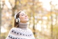 Woman listening to music and breathing in autumn Royalty Free Stock Photo