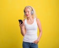 Woman listening to music on headset from her phone Royalty Free Stock Photo