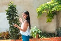 Woman listening to music on her cell phone and dancing in her backyard Royalty Free Stock Photo