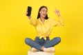 Woman Listening To Music Via Smart Speaker Over Yellow Background Royalty Free Stock Photo