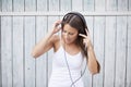 Woman listening wireless music with headphones from a smart phone Royalty Free Stock Photo