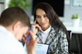 Woman listens attentively to upset office employee