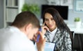 Woman listens attentively to upset office employee