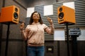 Woman listens to music in speaker system store