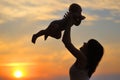 Woman with little baby as silhouette