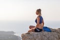 Woman with little bag on the rock