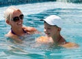 Woman and little boy bathes in pool Royalty Free Stock Photo