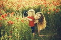 Woman and little boy or child in field of poppy Royalty Free Stock Photo