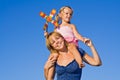 Woman with little girl against summer sky Royalty Free Stock Photo