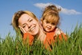 Woman and little girl in the grass Royalty Free Stock Photo