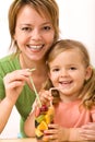 Woman and little girl having a fruity refreshment