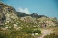 Woman and little girl hiking in a trail on highlands