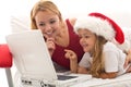 Woman and little girl playing on a laptop Royalty Free Stock Photo