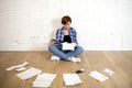 Woman at living room floor with calculator and bank and bills paperwork and documents doing domestic financial accounting Royalty Free Stock Photo