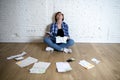 Woman at living room floor with calculator and bank and bills paperwork and documents doing domestic financial accounting Royalty Free Stock Photo