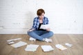 Woman at living room floor with calculator and bank and bills paperwork and documents doing domestic financial accounting