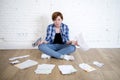 Woman at living room floor with calculator and bank and bills paperwork and documents doing domestic financial accounting Royalty Free Stock Photo