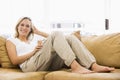 Woman in living room listening to MP3 player Royalty Free Stock Photo