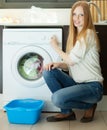 Woman loading clothes into the washing machine in home Royalty Free Stock Photo