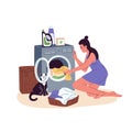 Woman loading dirty clothes from laundry basket into washer drum. Housewife putting garments into washing machine