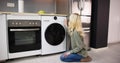 Woman Loading Dirty Clothes In Washing Machine For Washing Royalty Free Stock Photo