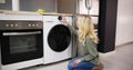 Woman Loading Dirty Clothes In Washing Machine For Washing Royalty Free Stock Photo