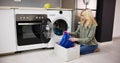 Woman Loading Dirty Clothes In Washing Machine For Washing Royalty Free Stock Photo