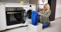 Woman Loading Dirty Clothes In Washing Machine For Washing Royalty Free Stock Photo