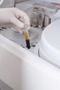 Woman loading samples in biochemical analyzer Royalty Free Stock Photo