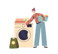 Woman loading wash machine to clean clothes. Young female housekeeper. Household activities