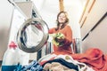 Woman loading washing machineWoman Loading Dirty Clothes In Washing Machine For Washing Royalty Free Stock Photo