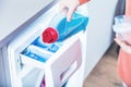 Woman loading washing machineWoman Loading Dirty Clothes In Washing Machine For Washing Royalty Free Stock Photo