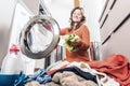 Woman loading washing machineWoman Loading Dirty Clothes In Washing Machine For Washing Royalty Free Stock Photo