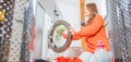 Woman loading washing machineWoman Loading Dirty Clothes In Washing Machine For Washing Royalty Free Stock Photo