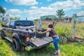 A woman loads garbage onto a pickup truck in Paraguay. Royalty Free Stock Photo