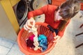 Woman loding laundry in washing machine