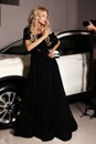 Woman with long blond hair wears luxurious dress, arrived on red carpet event Royalty Free Stock Photo