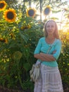 Woman with long blonde hair on a background of sunflowers, back light Royalty Free Stock Photo