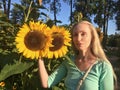 Woman with long blonde hair on a background of sunflowers Royalty Free Stock Photo