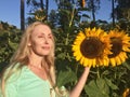 Woman with long blonde hair on a background of sunflowers Royalty Free Stock Photo