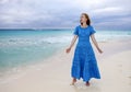 Woman in a long blue dress goes on the sea coast Cayo Largo island, Cuba Royalty Free Stock Photo